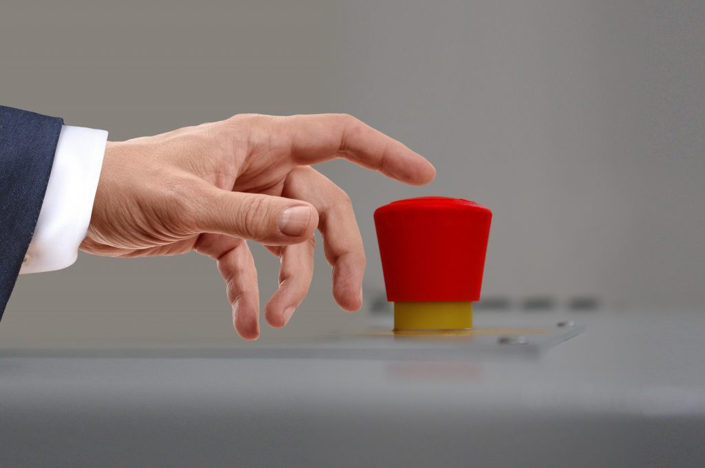 image of hand pressing big red button